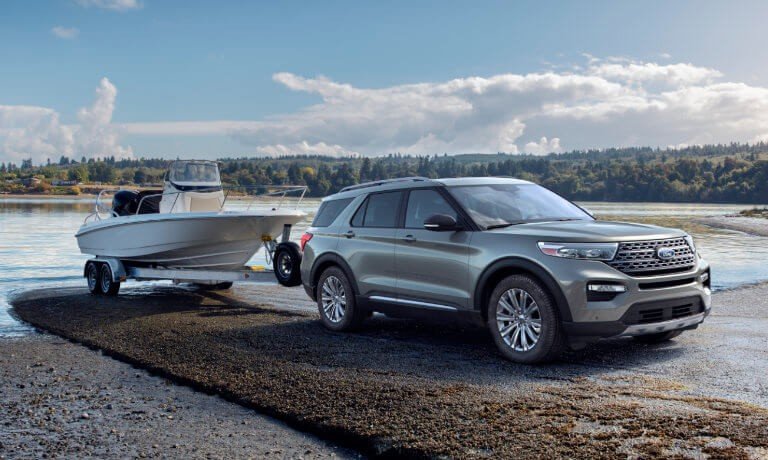 2021 Ford Explorer towing a boat by the lake