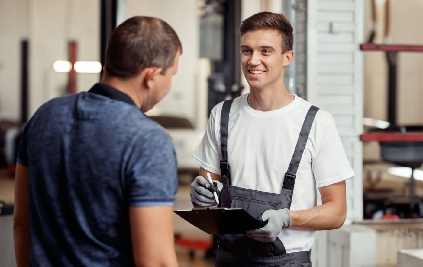 Ford Certified Technician discussing maintenance at Ford Service Center