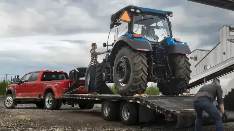 A diesel Super Duty® truck being prepared to tow a tractor