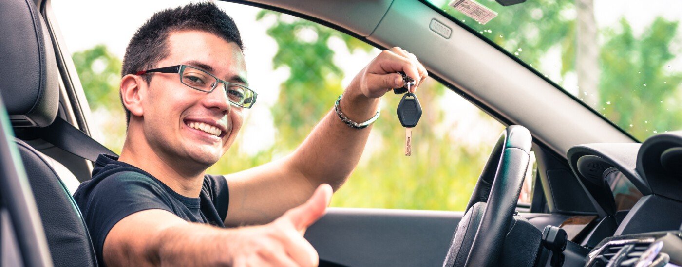 Man Giving Thumbs Up Holding Keys In Car