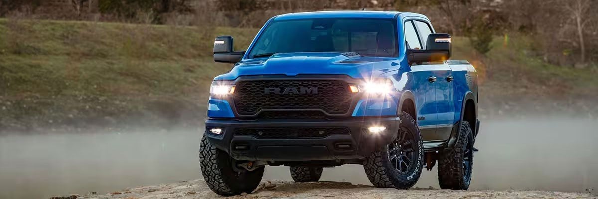 Blue 2025 Ram 1500 Rebel Crew Cab Parked on a Small Hill