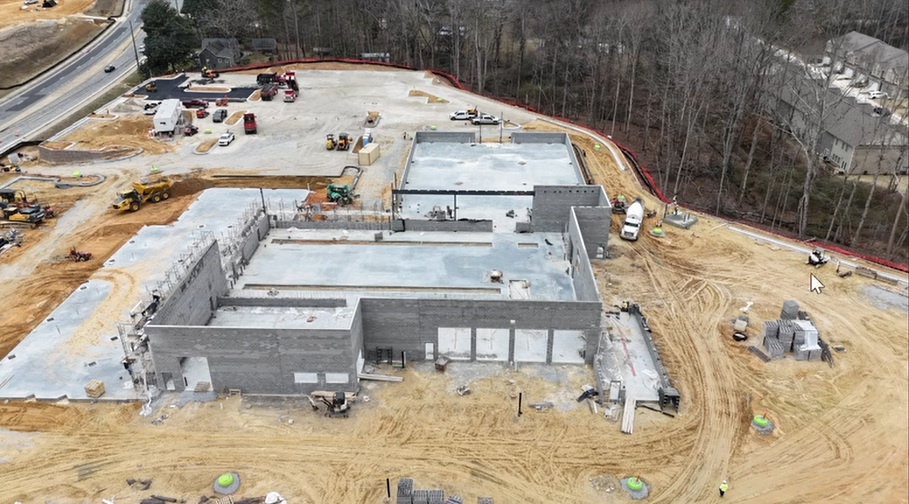 Active construction at Mercedes-Benz Buford service center with concrete work and equipment on site