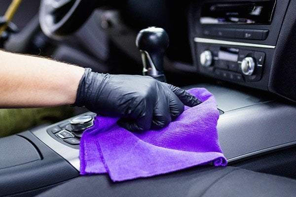 A man cleaning car interior, car detailing.