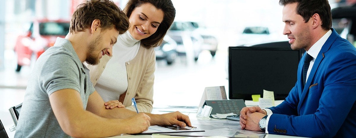 Couple signing paperwork