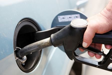 Man pumping gas into a recently cleaned Toyota gas tank in Westbury, NY.