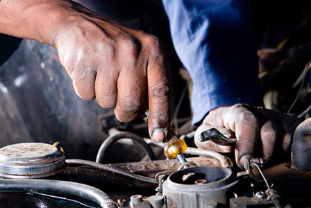 Mechanic at Westbury Toyota on Long Island performing engine tune-up.
