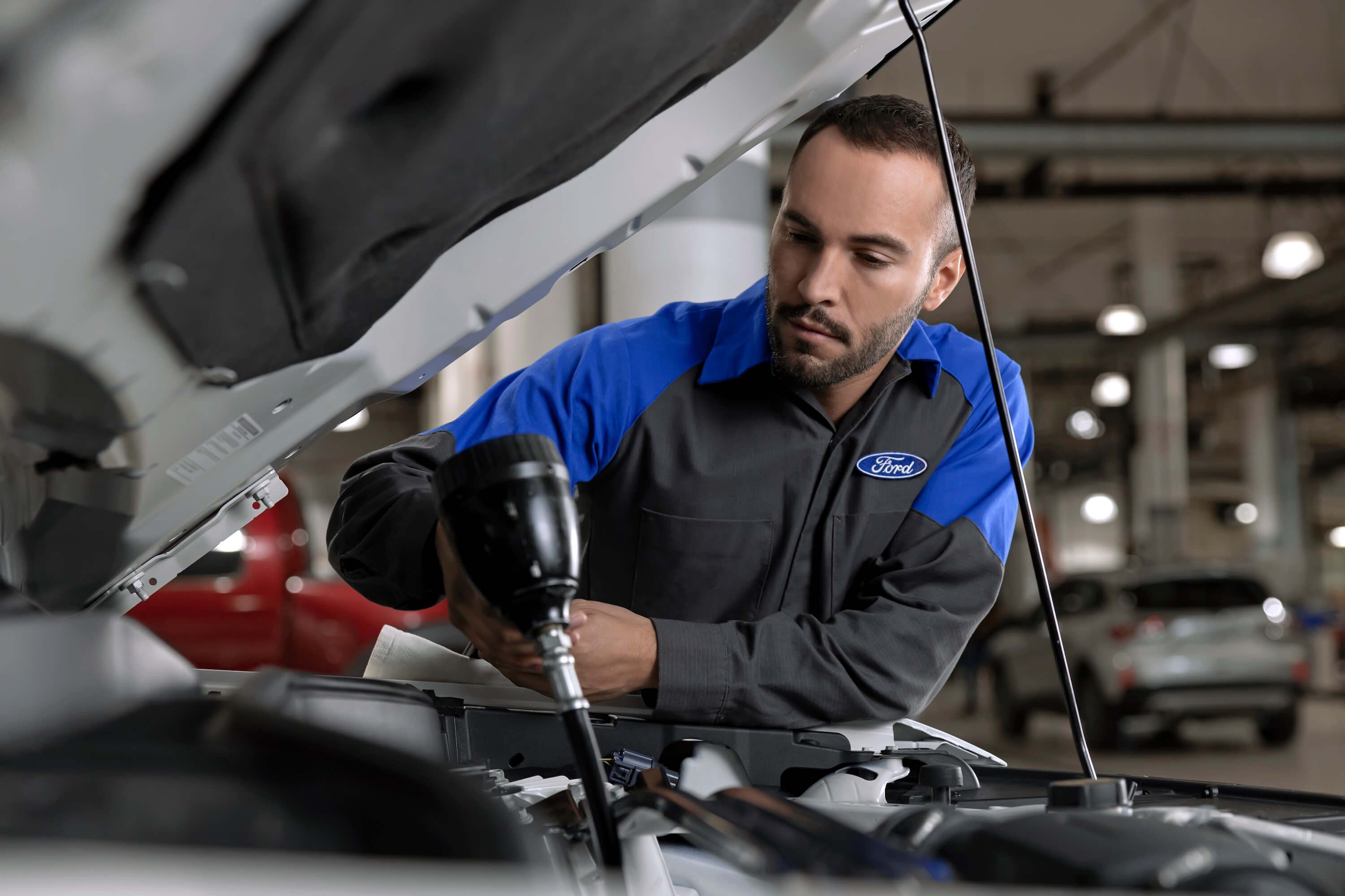 Mullinax Ford - Service Technician Changing Oil