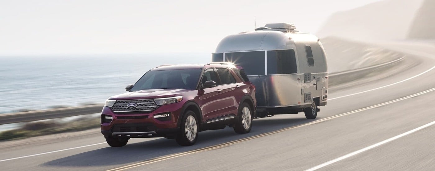 Purple 2023 Ford Explorer Hybrid towing a trailer