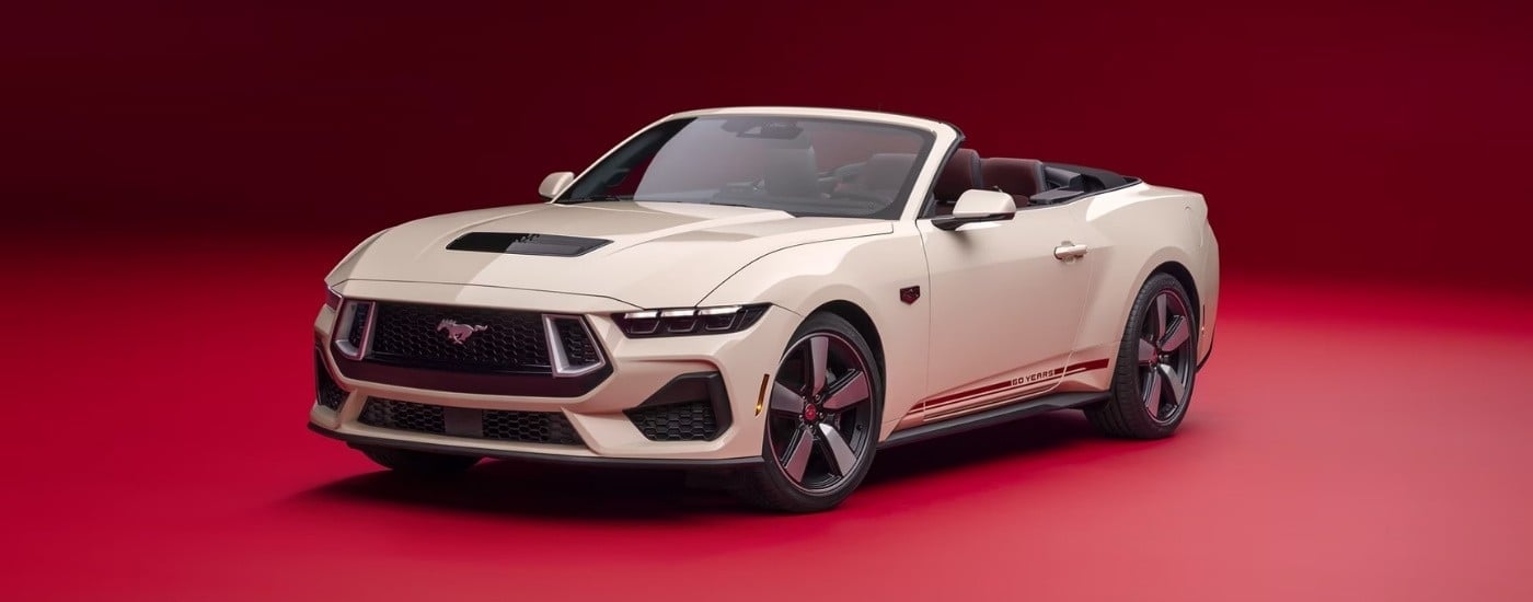 White 2025 Ford Mustang 60th Anniversary parked at a Ford dealer near Altamonte Springs