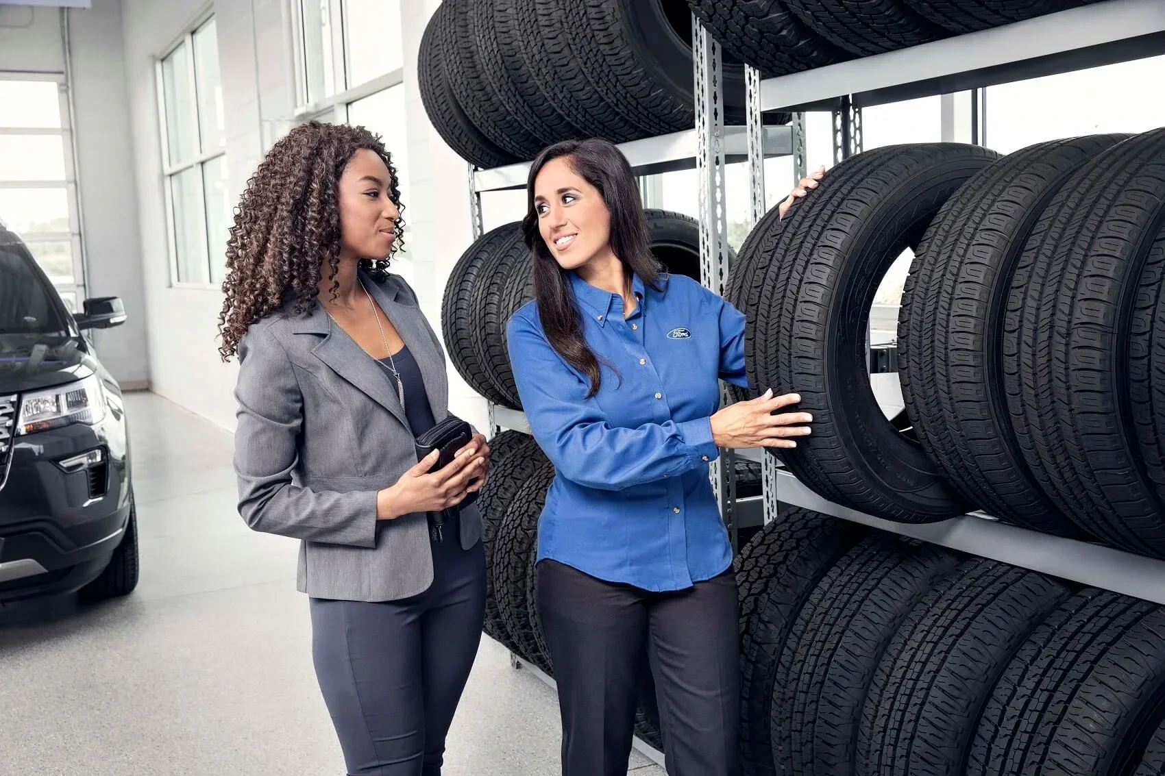 Woman Selecting New Tires - Tire Warranty - Mullinax Ford of Central Florida