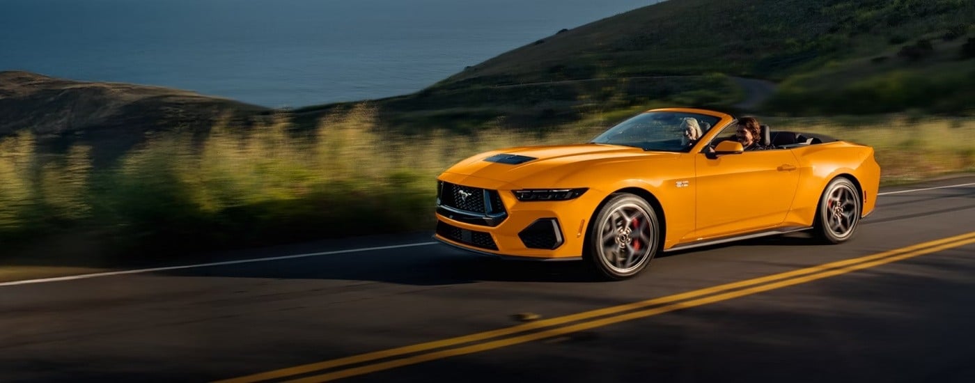 Yellow 2026 Ford Mustang GT driving to a Ford dealer near Winter Garden