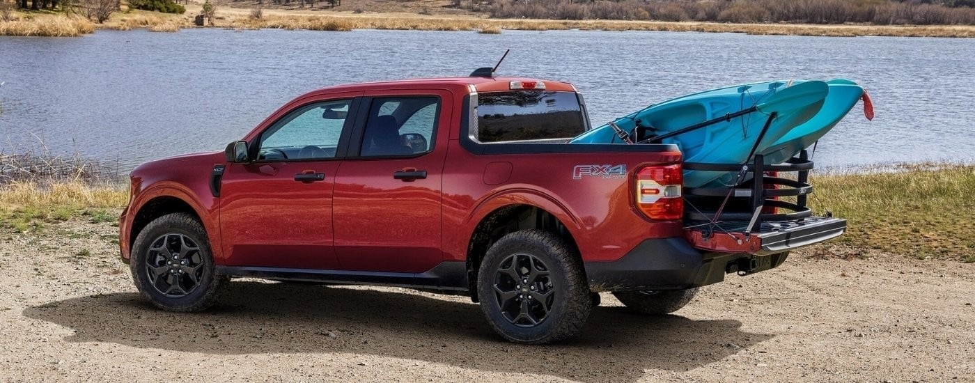 Red 2025 Ford Maverick XLT parked near a lake