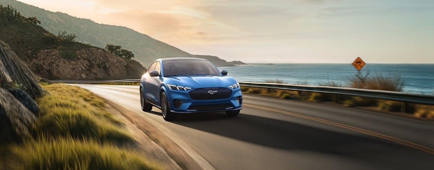 Blue 2025 Ford Mustang Mach-E driving to a Ford dealer near Orlando
