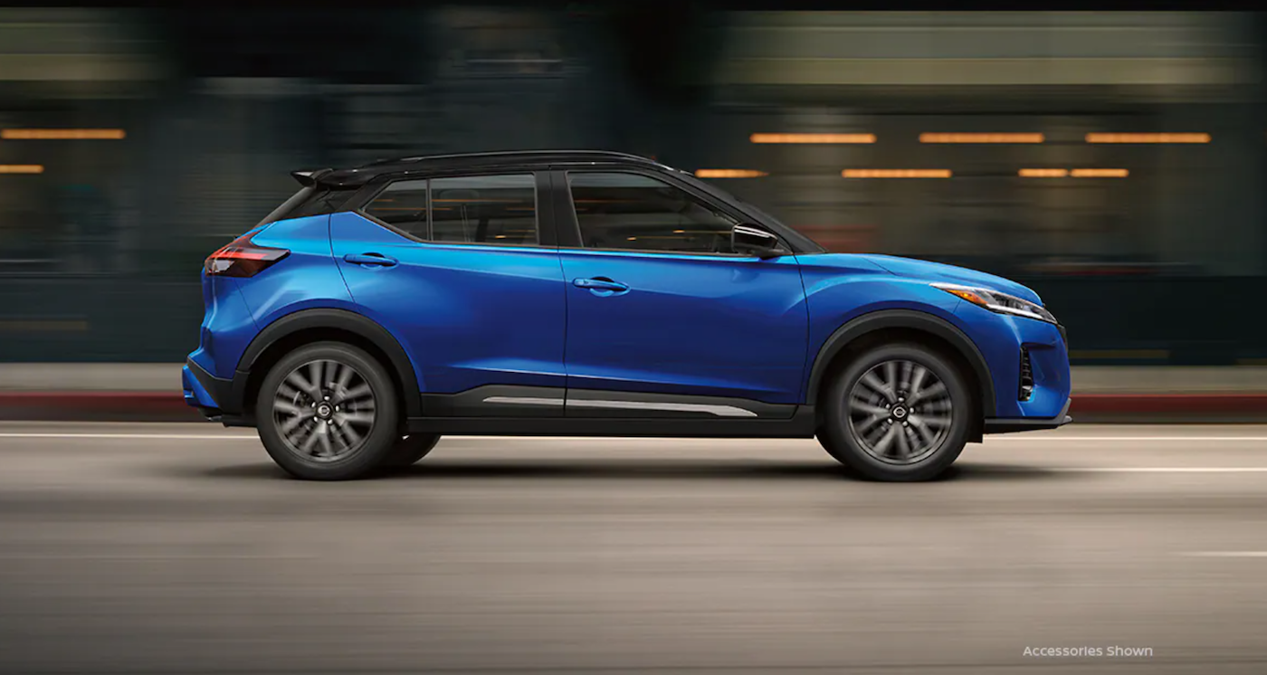 The 2021 Nissan Kicks driving on a highway.