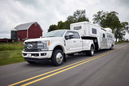 2017 ford f-series super duty pulling a trailer at the farm